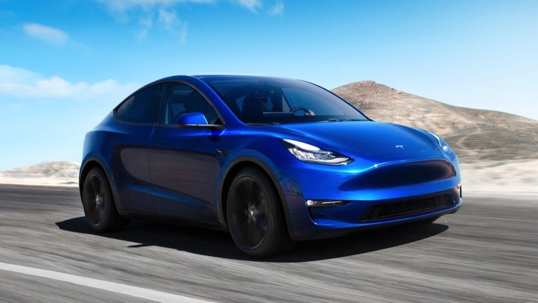 Blue Tesla Model Y on the road