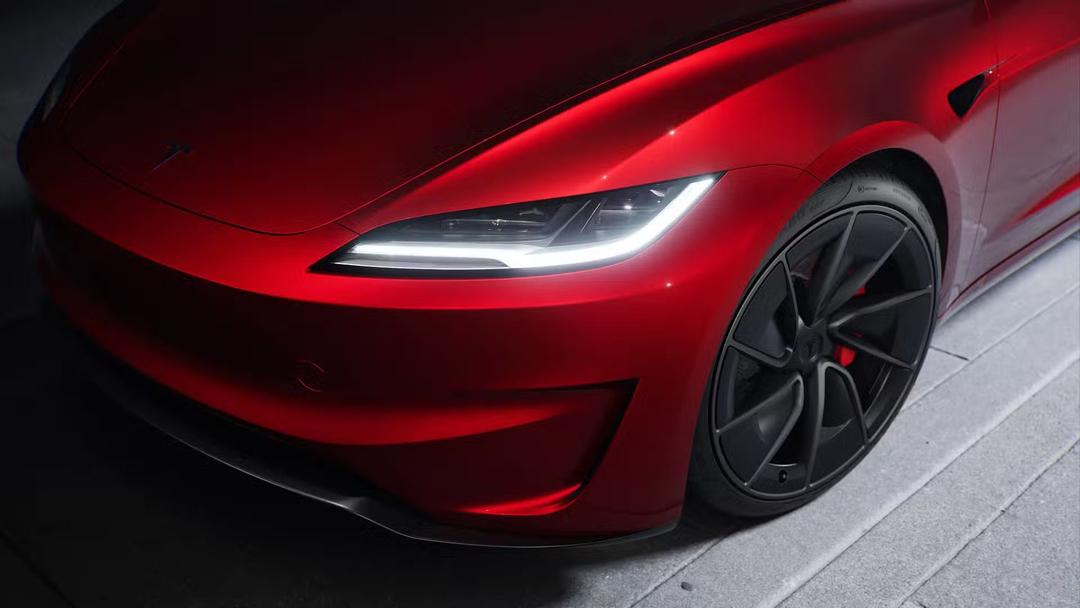 2024 Tesla Model 3 Performance in read with headlights zoomed in