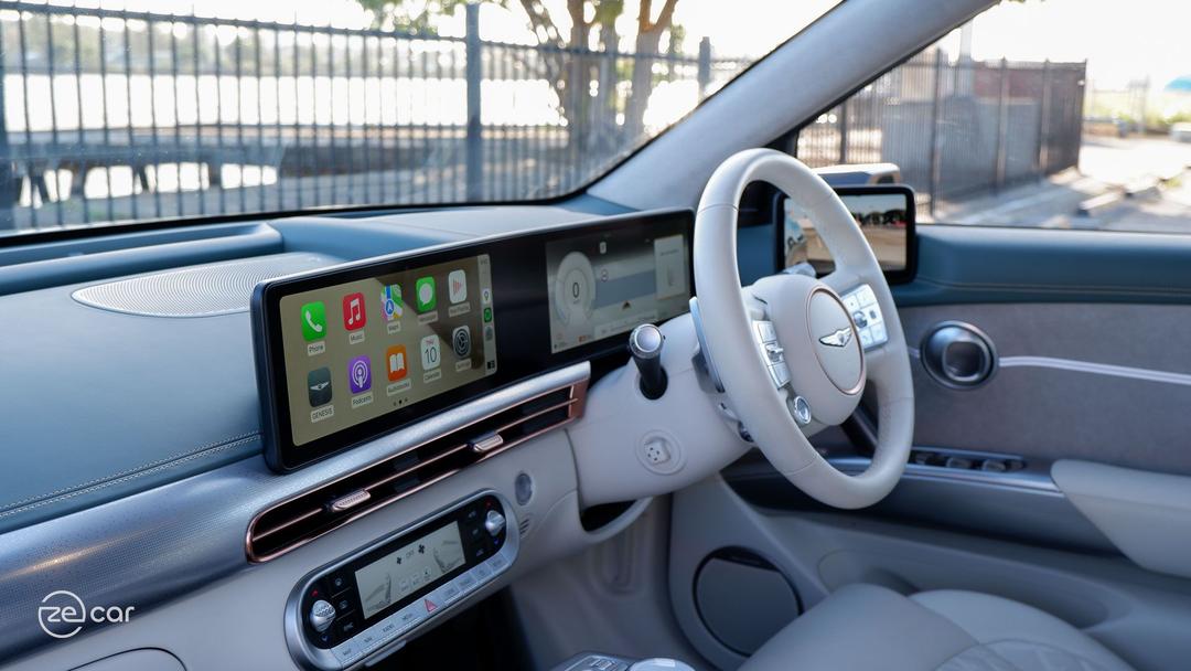 Genesis GV60 AWD white/green interior with Apple CarPlay displayed