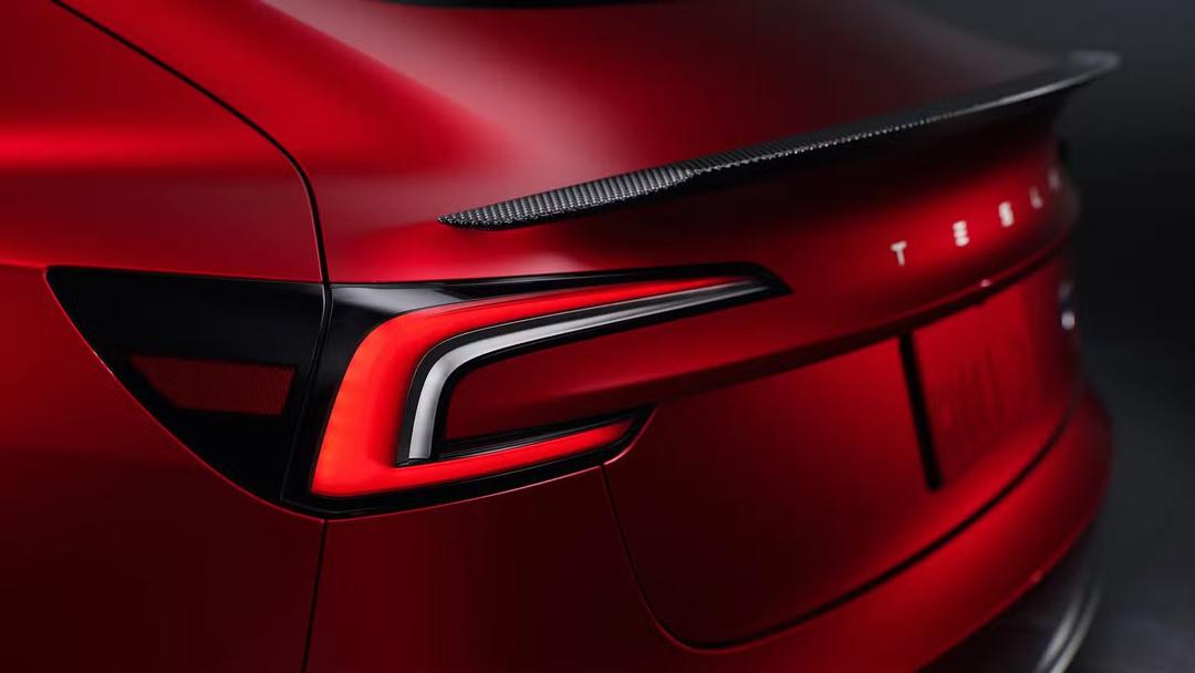 2024 Tesla Model 3 Performance in red with tail lights zoomed in