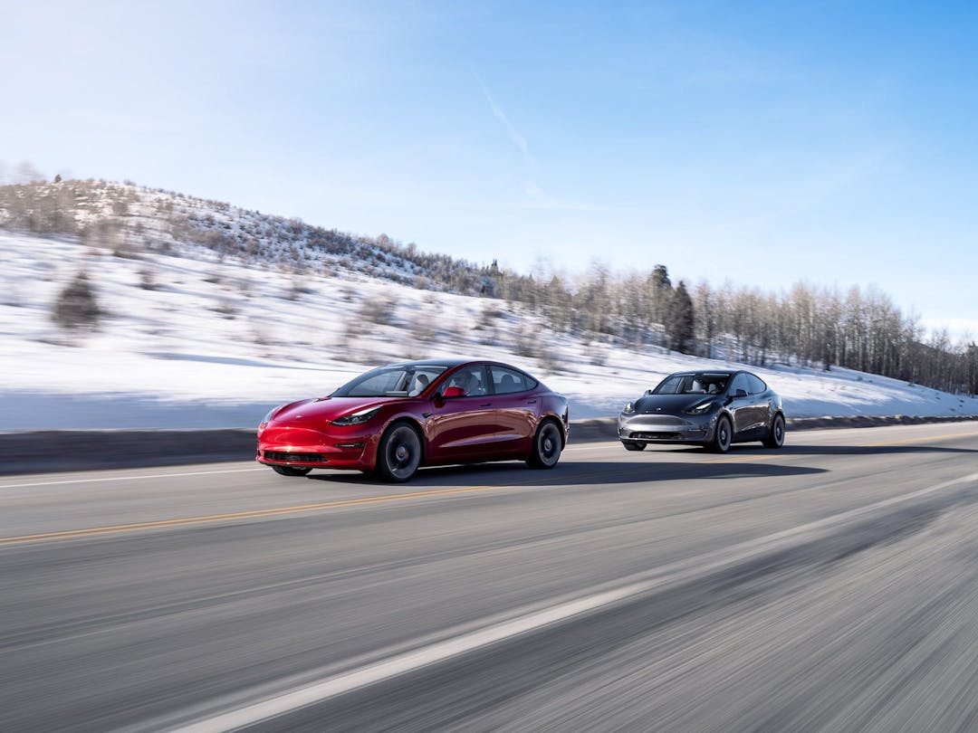 Tesla Model 3 and Model Y driving in snowy weather