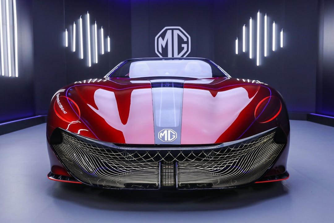 MG Cyberster in red front view with MG logo background