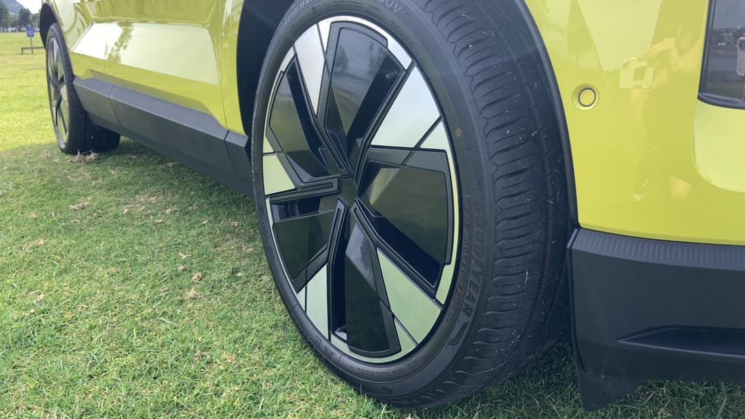 Volvo EX30 in moss yellow zoomed in on front wheels