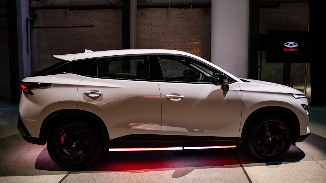 Chery Omoda E5 in white side view in showroom