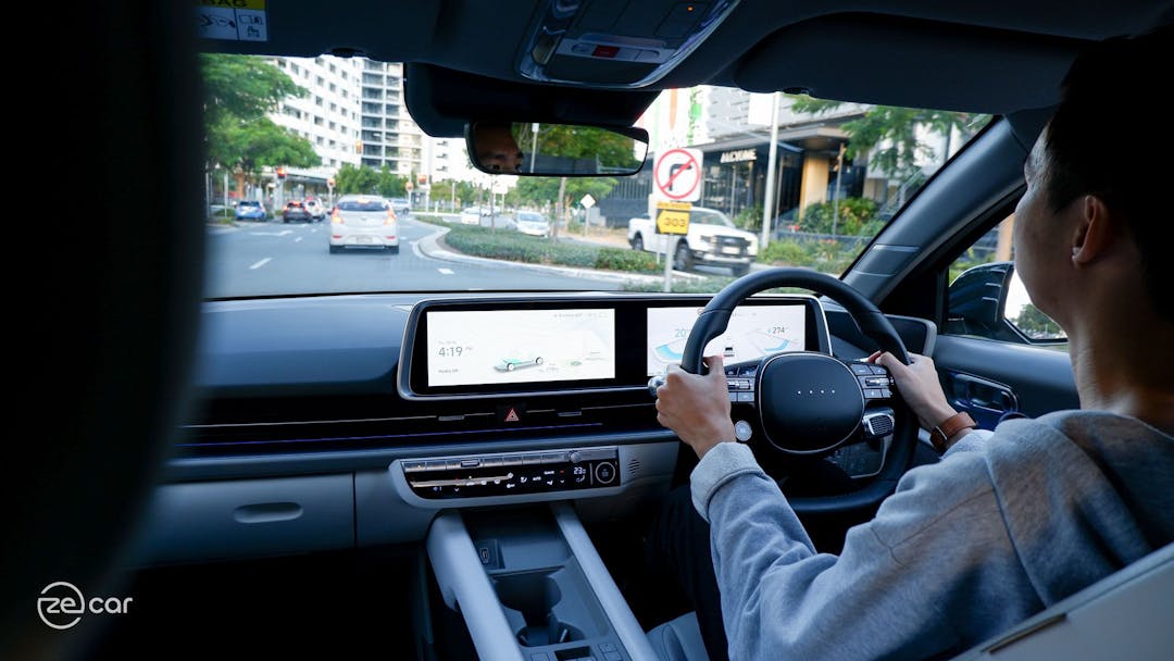 Hyundai Ioniq 6 instrument display and person driving