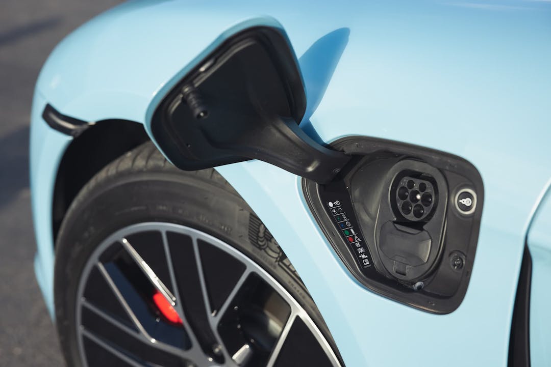 Blue Porsche Taycan EV charging port