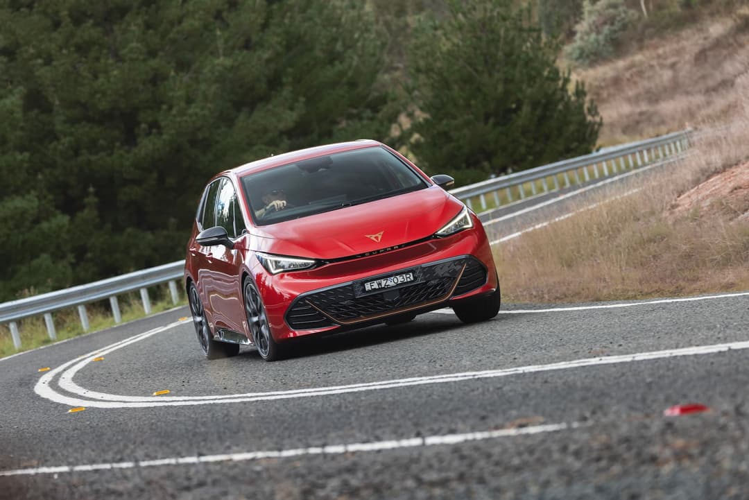 Red Cupra Born driving and rear logo