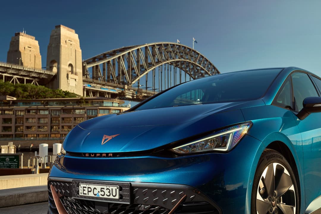Blue Cupra Born in front of Sydney harbour bridge Blue Cupra Born in front of Sydney harbour bridge