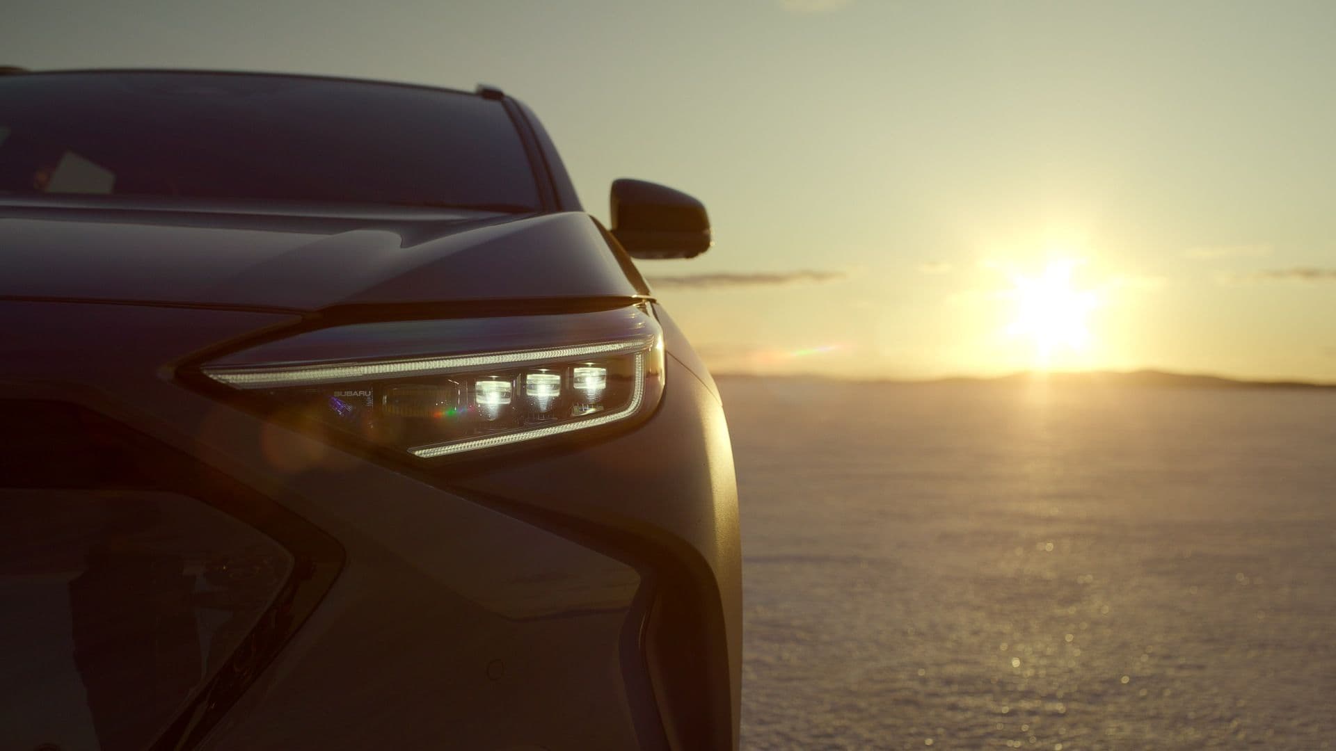 2024 Subaru Solterra front view zoomed in with sunrise background 2024 Subaru Solterra front view zoomed in with sunrise background