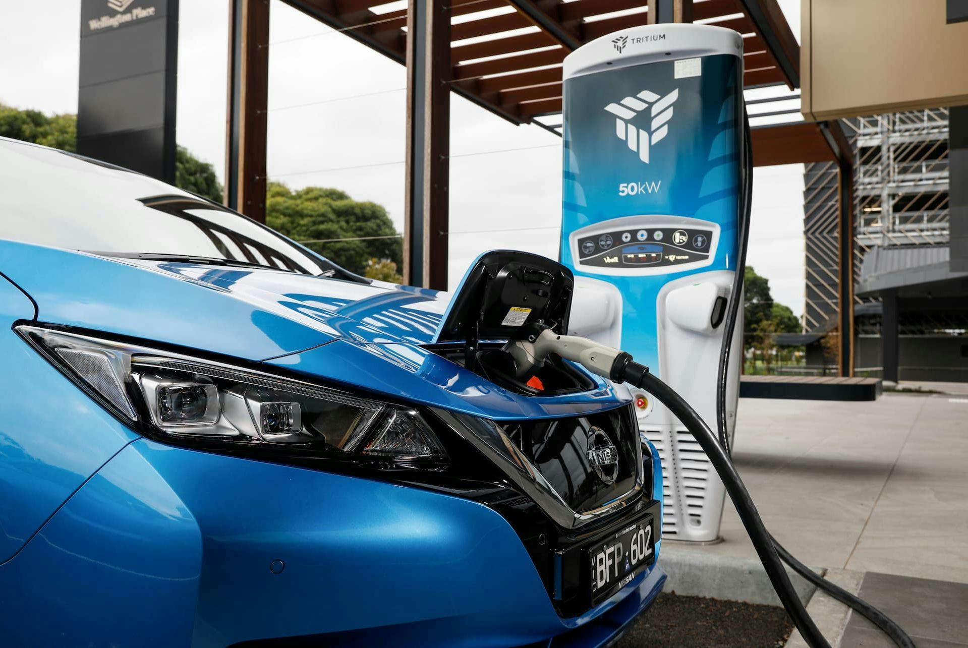 Blue Nissan Leaf EV charging at Tritium fast charging station