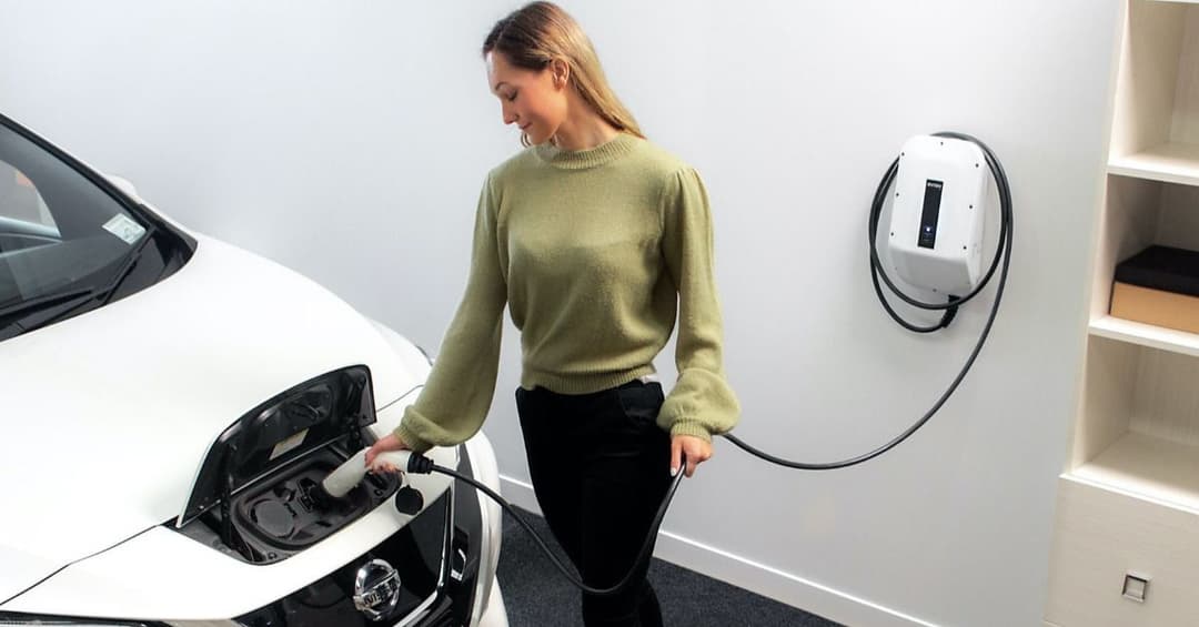woman charging her ev woman charging her ev