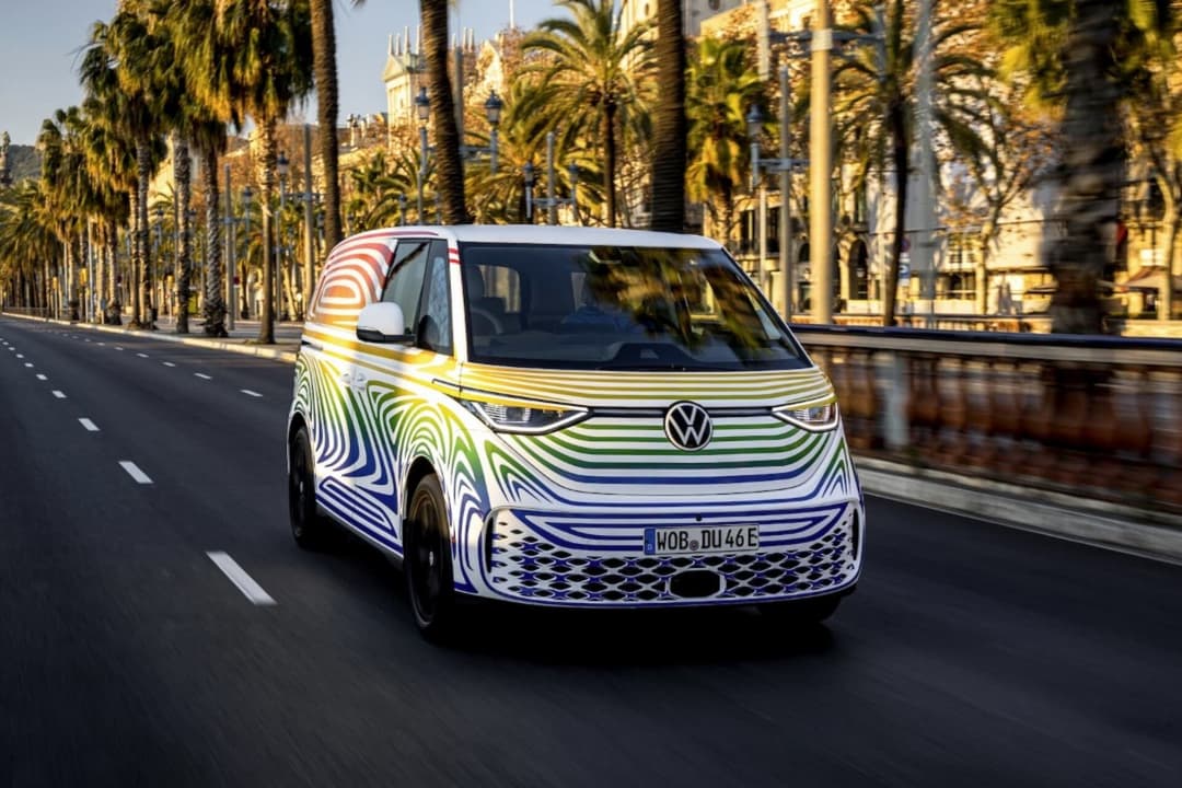 Volkswagen ID.Buzz driving in sunset front view Volkswagen ID.Buzz driving in sunset front view