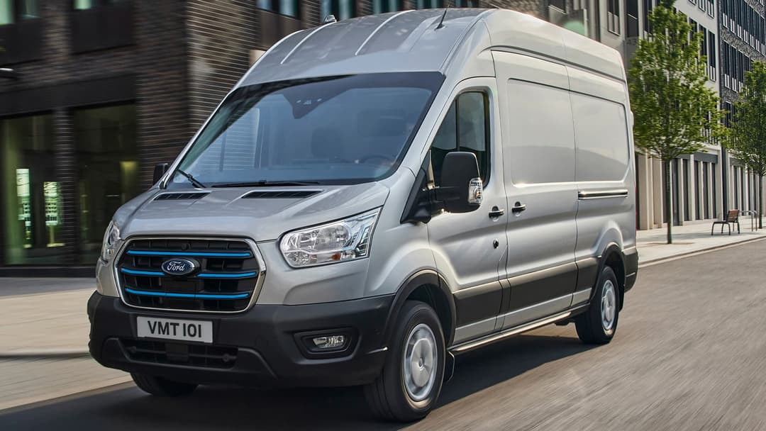 Grey Ford e-Transit driving in the city roads Grey Ford e-Transit driving in the city roads