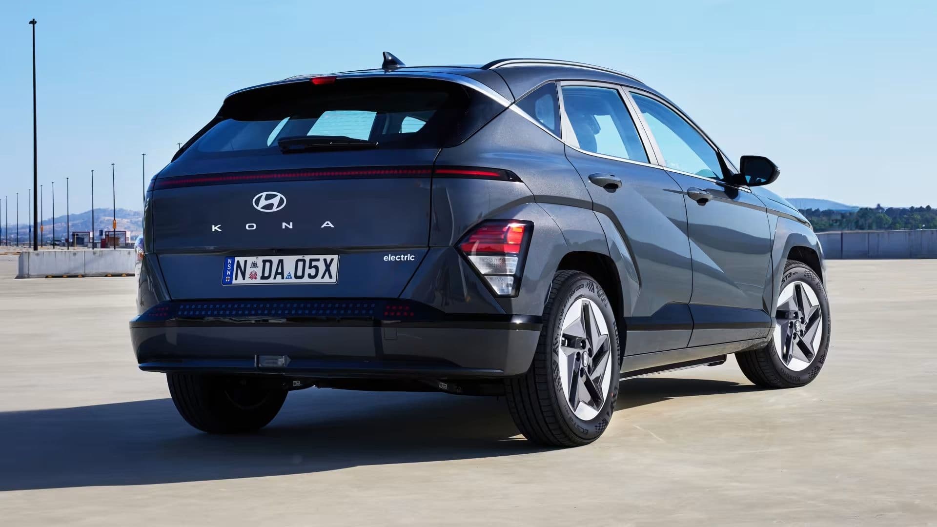 Hyundai Kona in denim blue parked rear view Hyundai Kona in denim blue parked rear view
