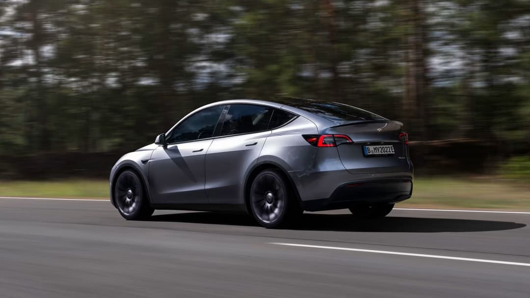2024 Tesla Model Y in quicksilver driving on highway 2024 Tesla Model Y in quicksilver driving on highway