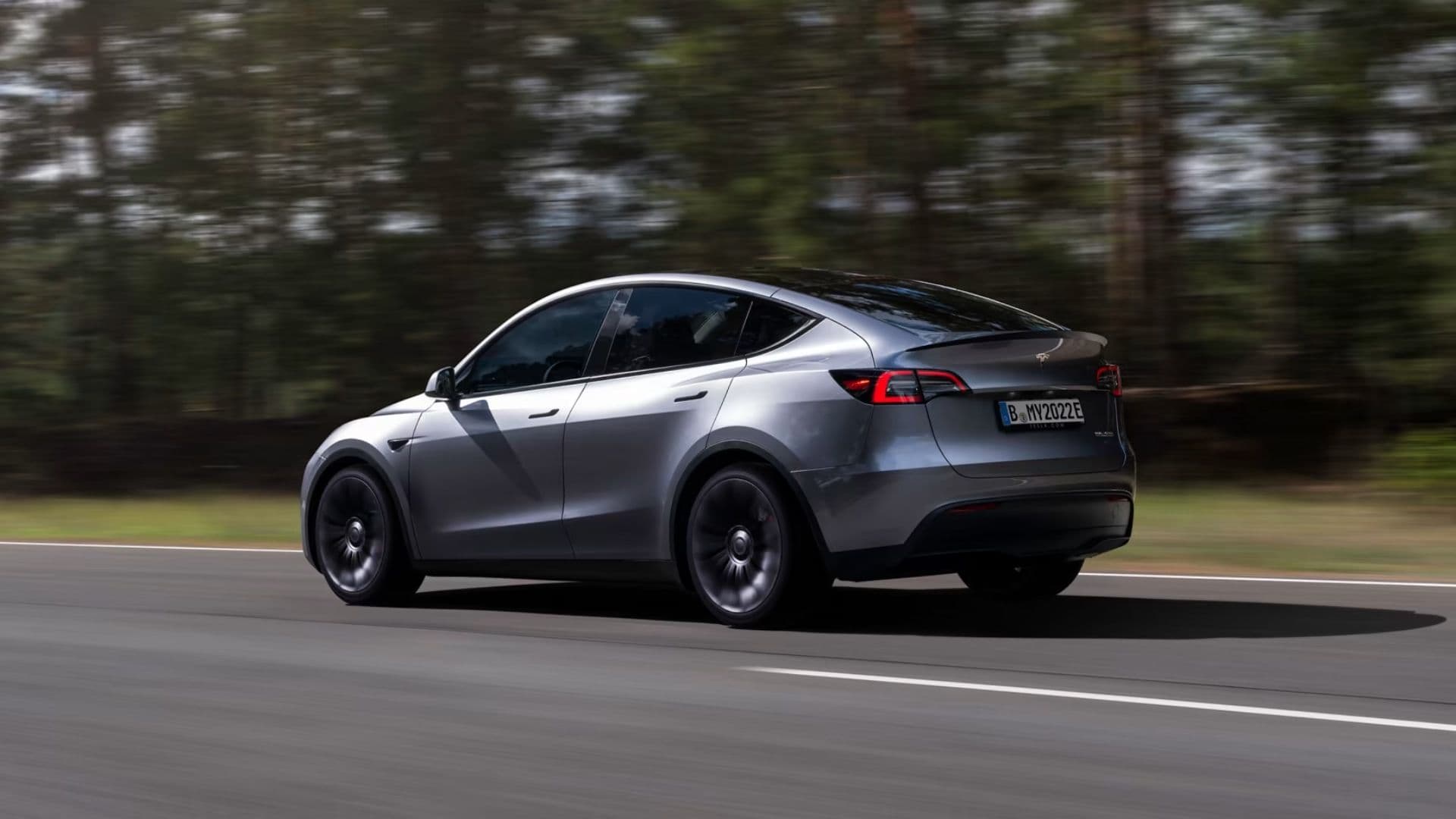 2024 Tesla Model Y in quicksilver driving on highway 2024 Tesla Model Y in quicksilver driving on highway