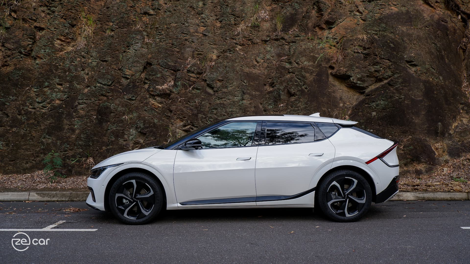 White Kia EV6 GT-Line on side of rocks White Kia EV6 GT-Line on side of rocks