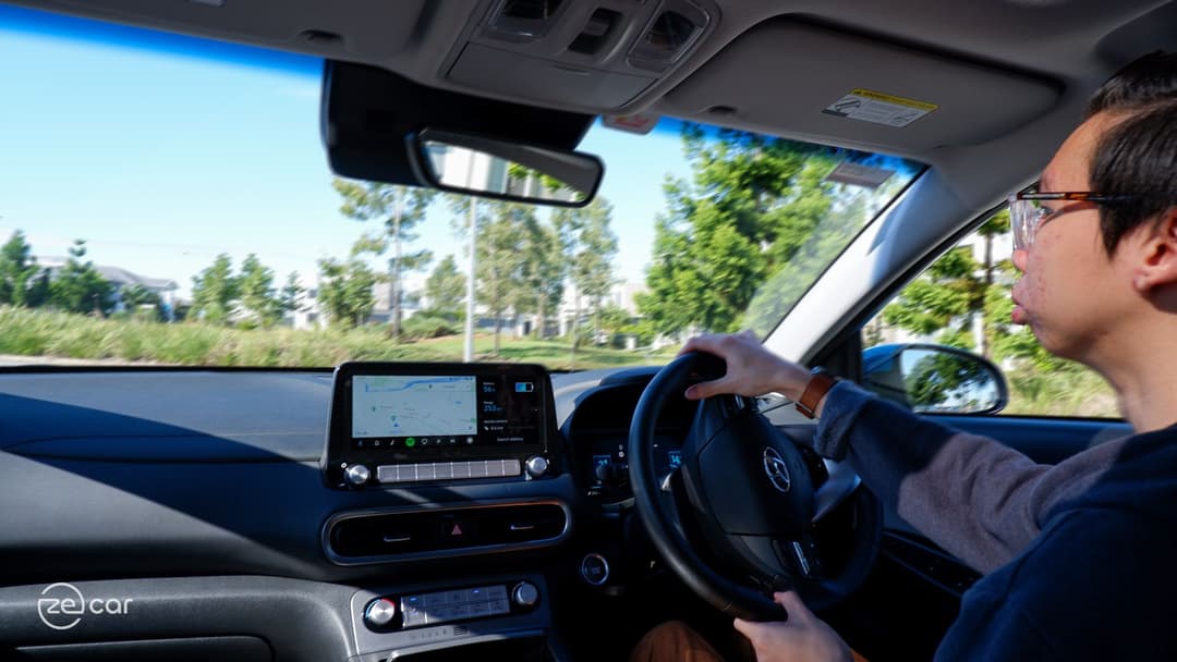 Person driving Hyundai Kona Electric interior dashboard view Person driving Hyundai Kona Electric interior dashboard view