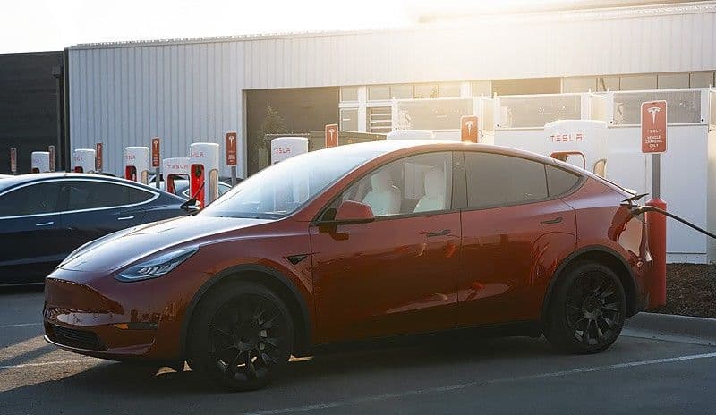 Tesla Model Y charging at supercharger Tesla Model Y charging at supercharger