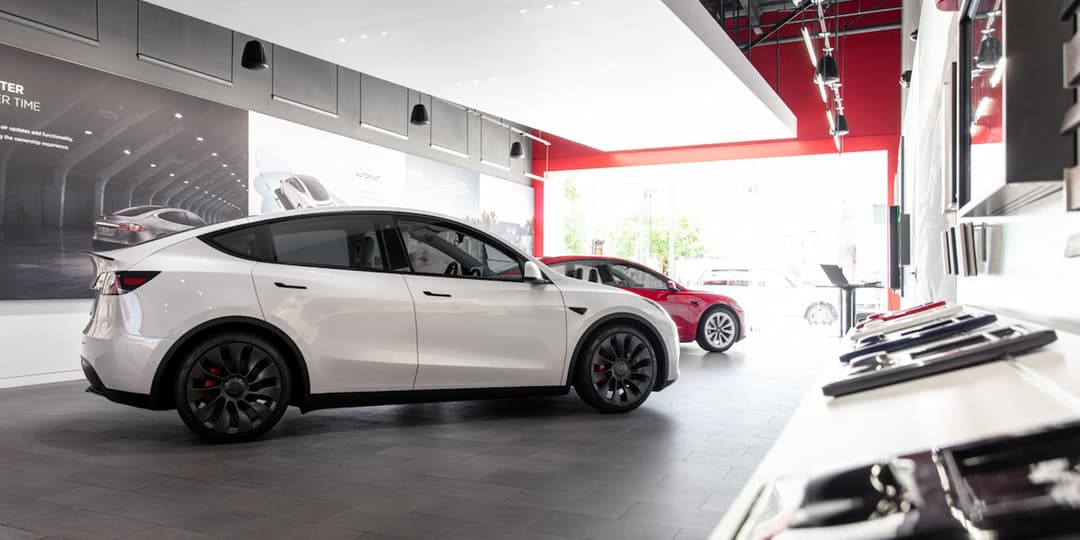 Tesla Model Y in front of Model 3 in Tesla showroom Tesla Model Y in front of Model 3 in Tesla showroom