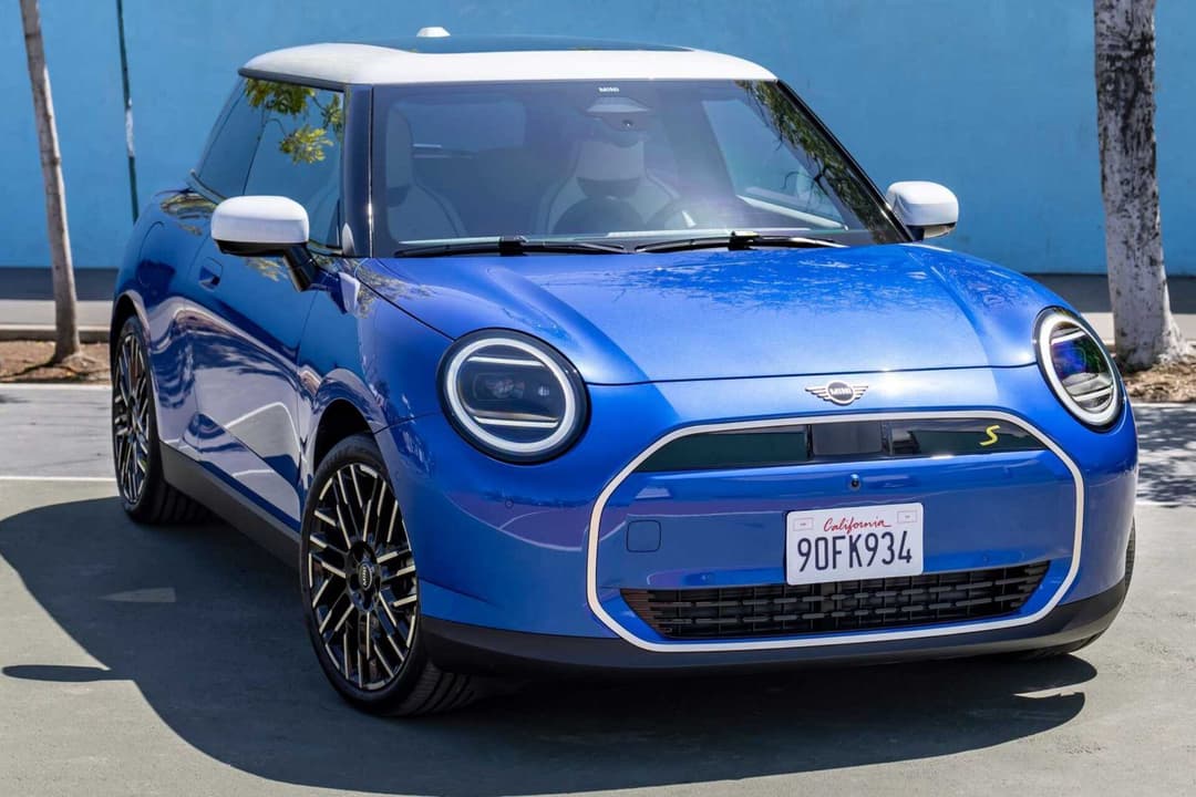 Mini Cooper EV in blue three quarter view parked on street Mini Cooper EV in blue three quarter view parked on street