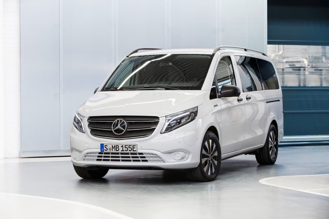 White Mercedes Benz eVito angled front view inside showroom white wall White Mercedes Benz eVito angled front view inside showroom white wall