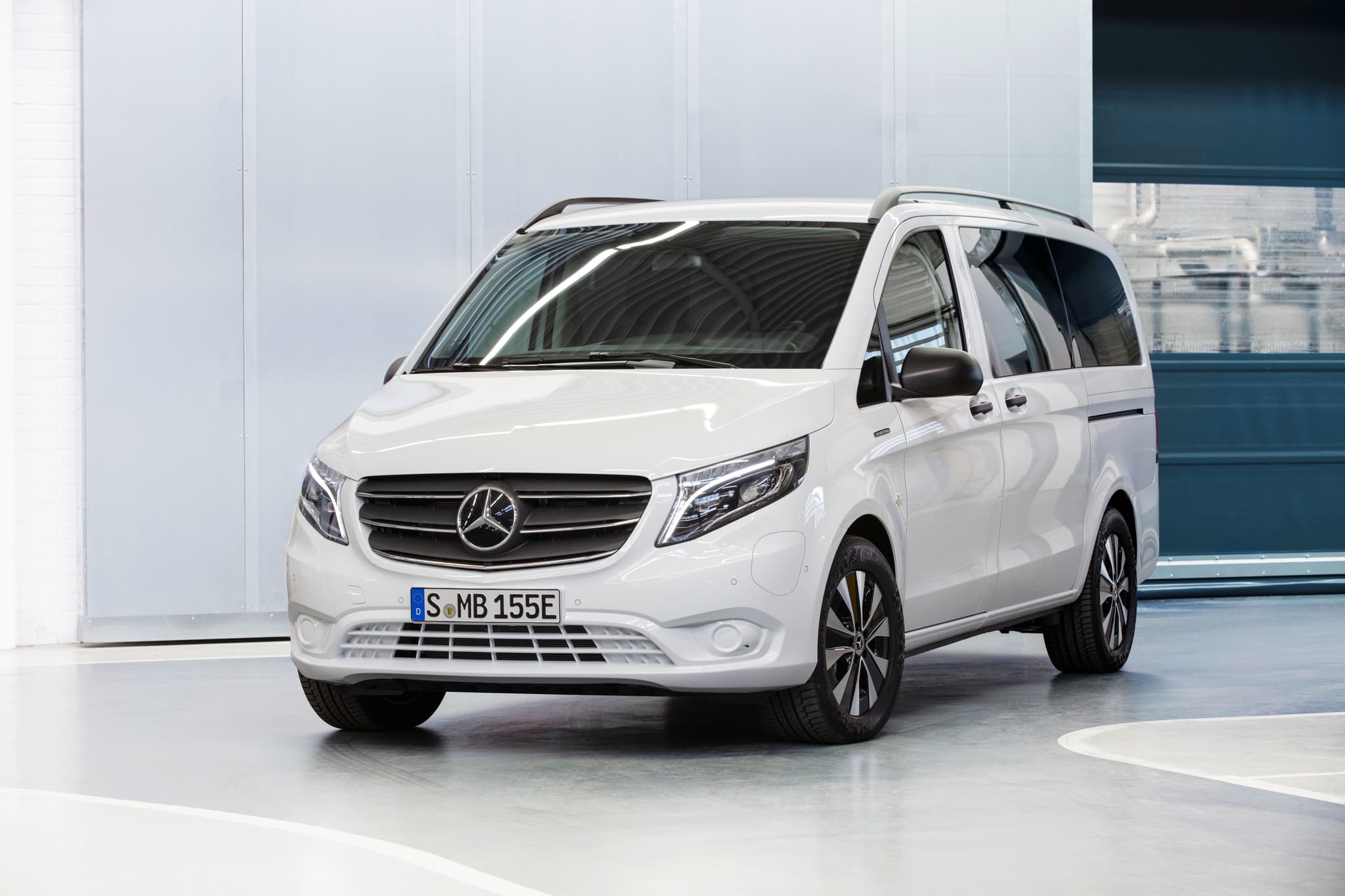 White Mercedes Benz eVito angled front view inside showroom white wall White Mercedes Benz eVito angled front view inside showroom white wall