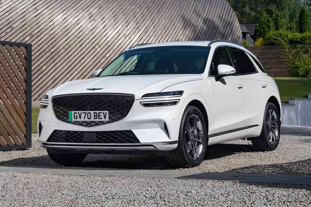 Genesis Electrified GV70 white parked on gravel road Genesis Electrified GV70 white parked on gravel road