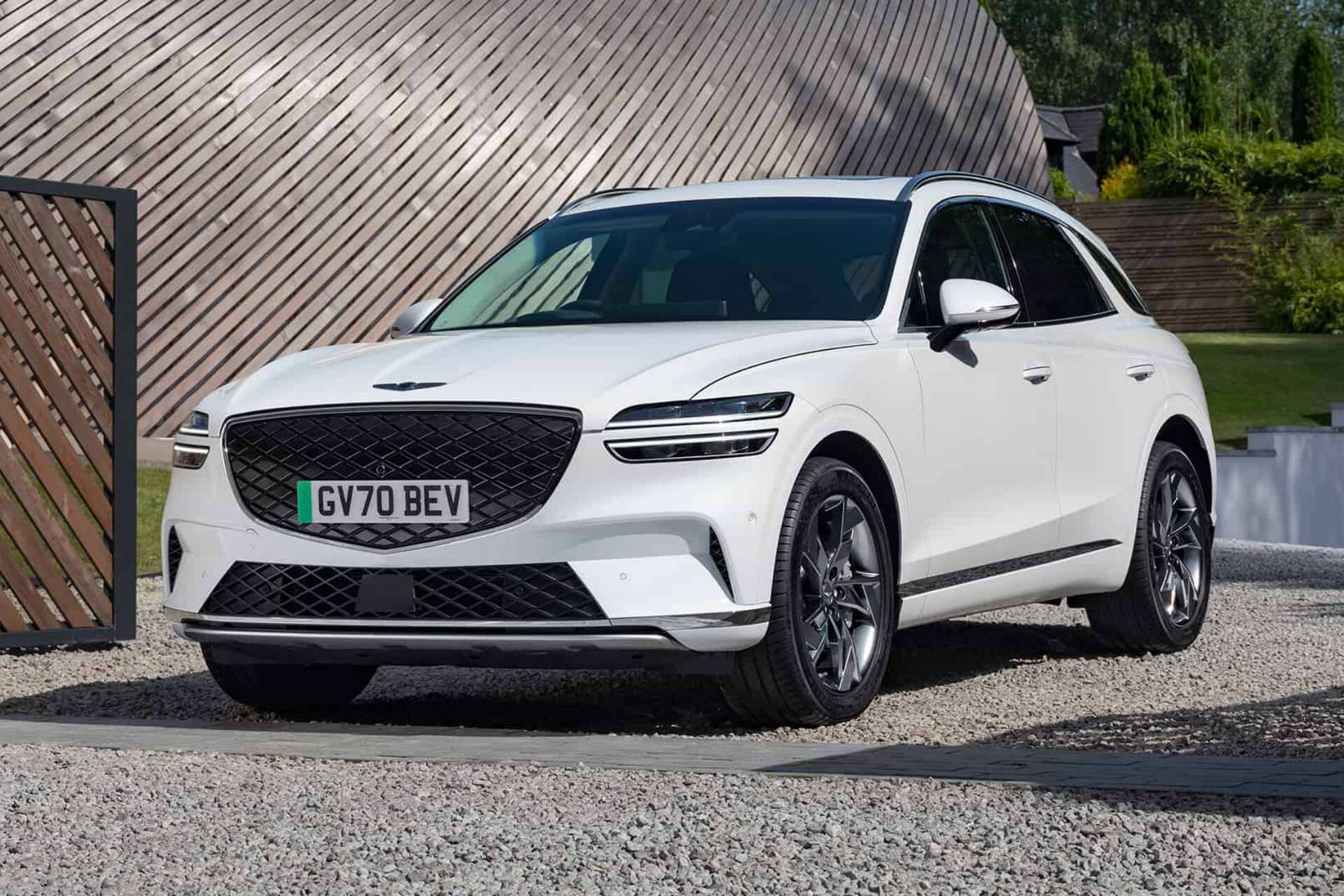 Genesis Electrified GV70 white parked on gravel road Genesis Electrified GV70 white parked on gravel road