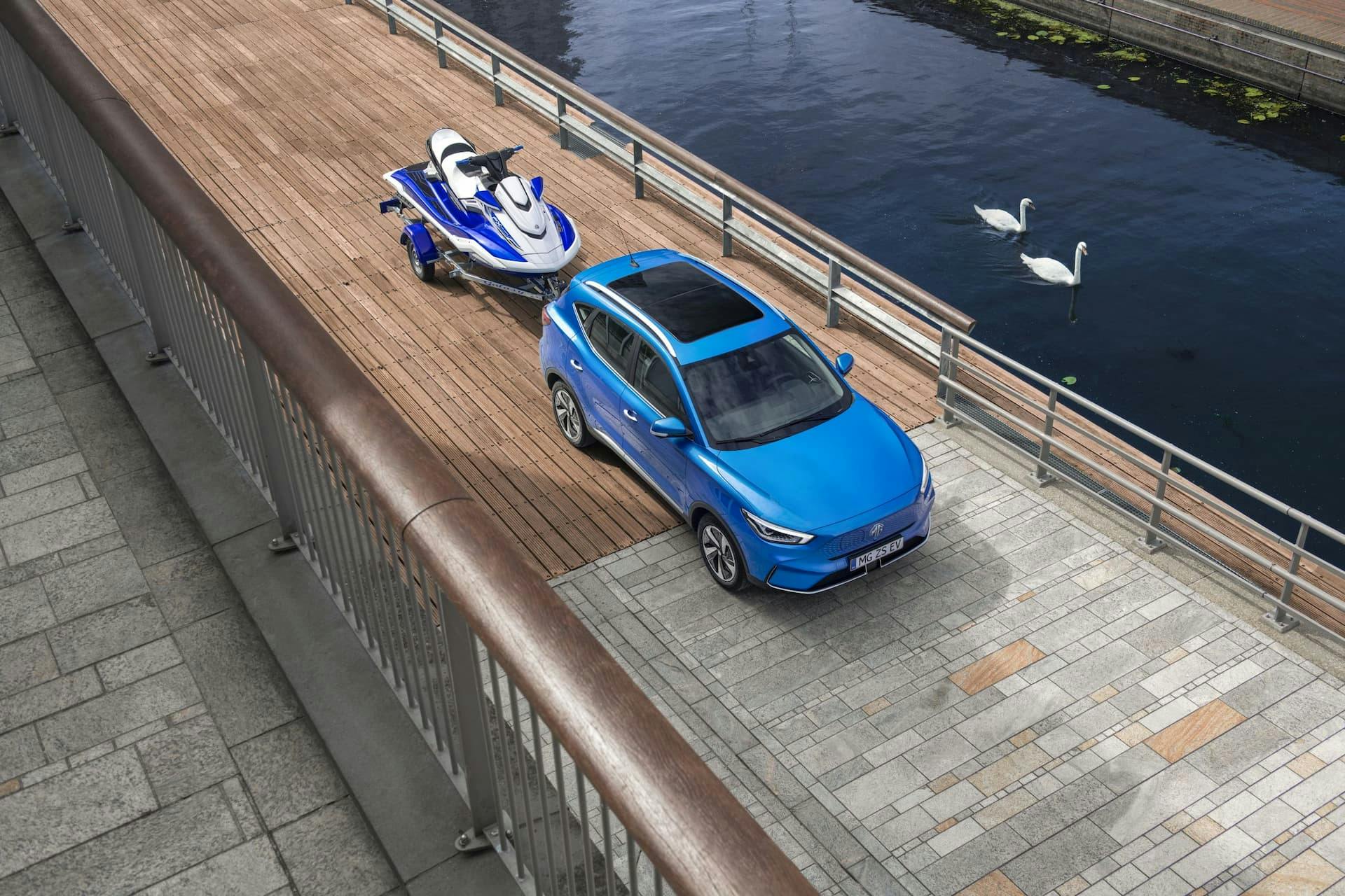 2022 MG ZS EV towing boat beside harbour