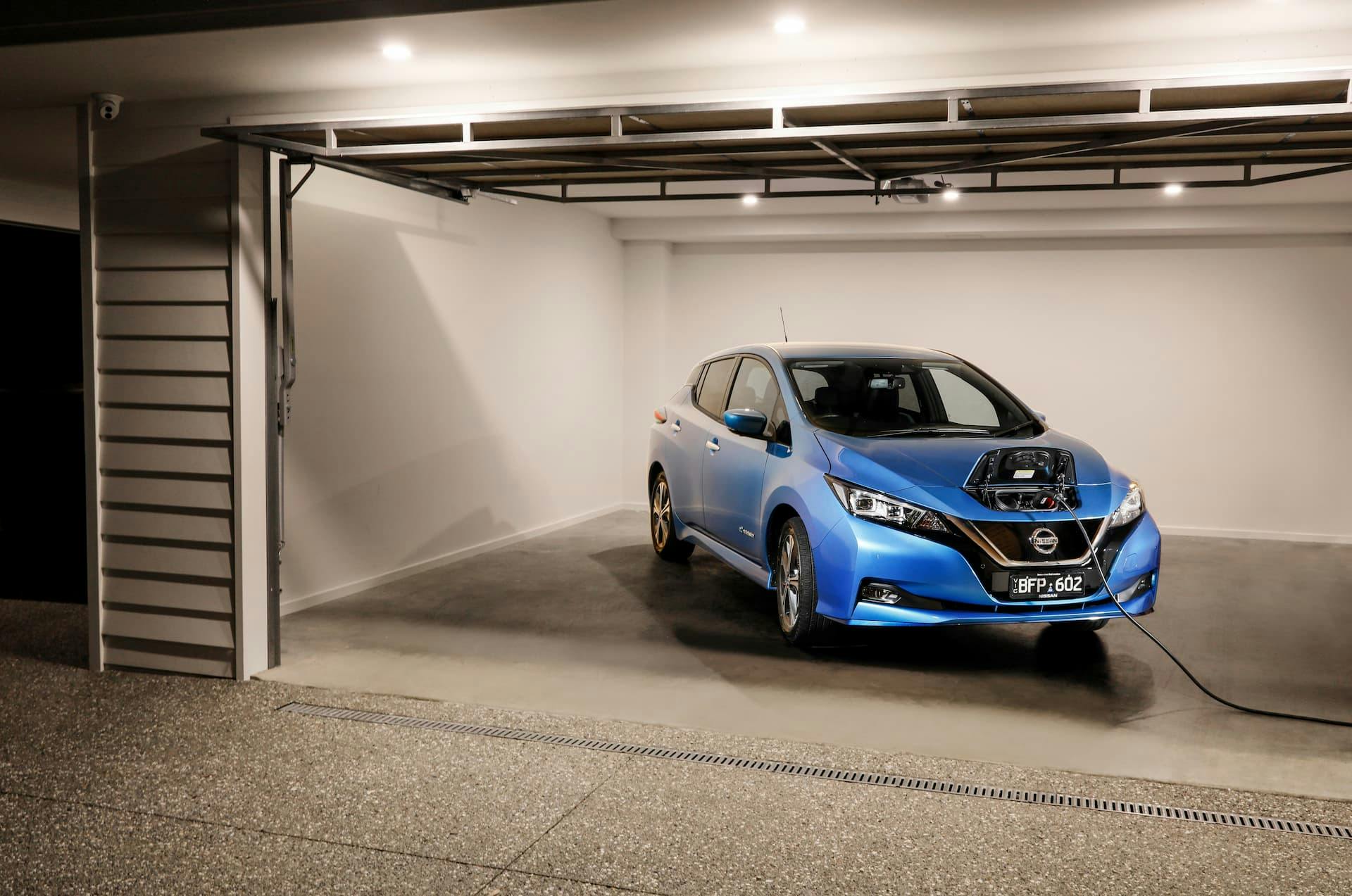 Nissan Leaf charging in home garage at night