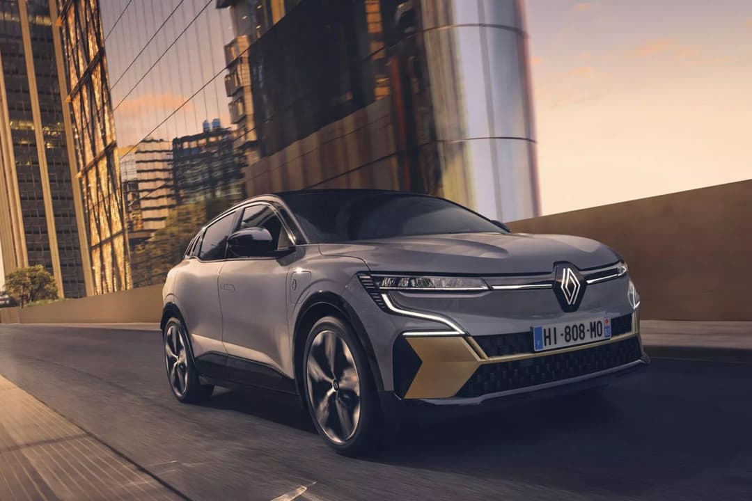 Renault Megane e-Tech three quarter view driving on road Renault Megane e-Tech three quarter view driving on road