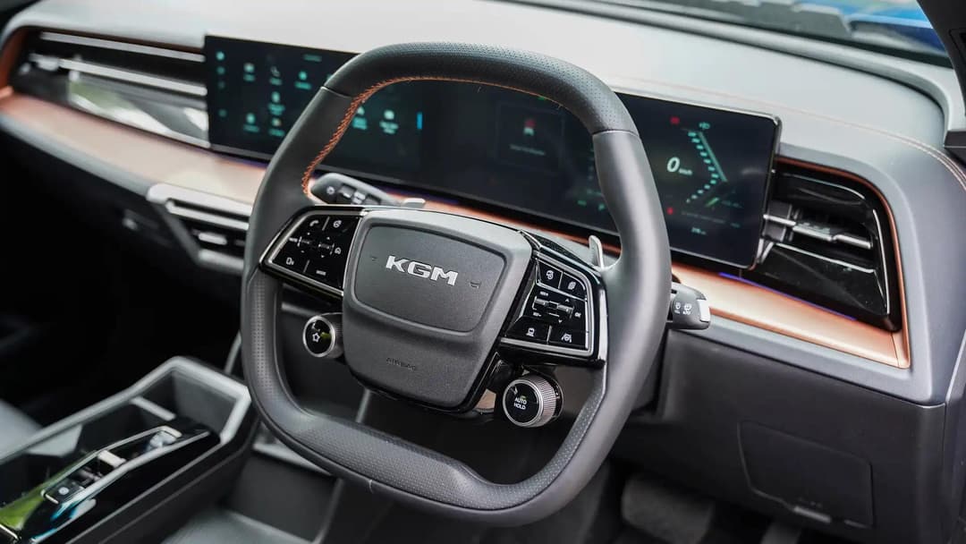 KGM Musso EV interior dashboard showing 12.3-inch touchscreen and digital instrument cluster KGM Musso EV interior dashboard showing 12.3-inch touchscreen and digital instrument cluster