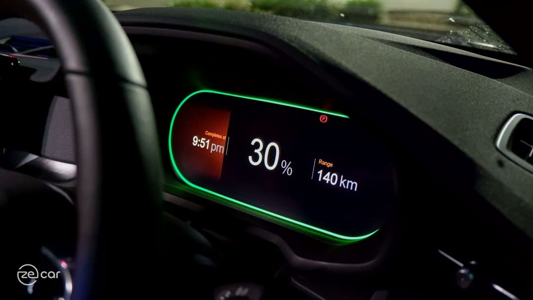 Polestar 2 charging screen and charging next to Tesla Model 3