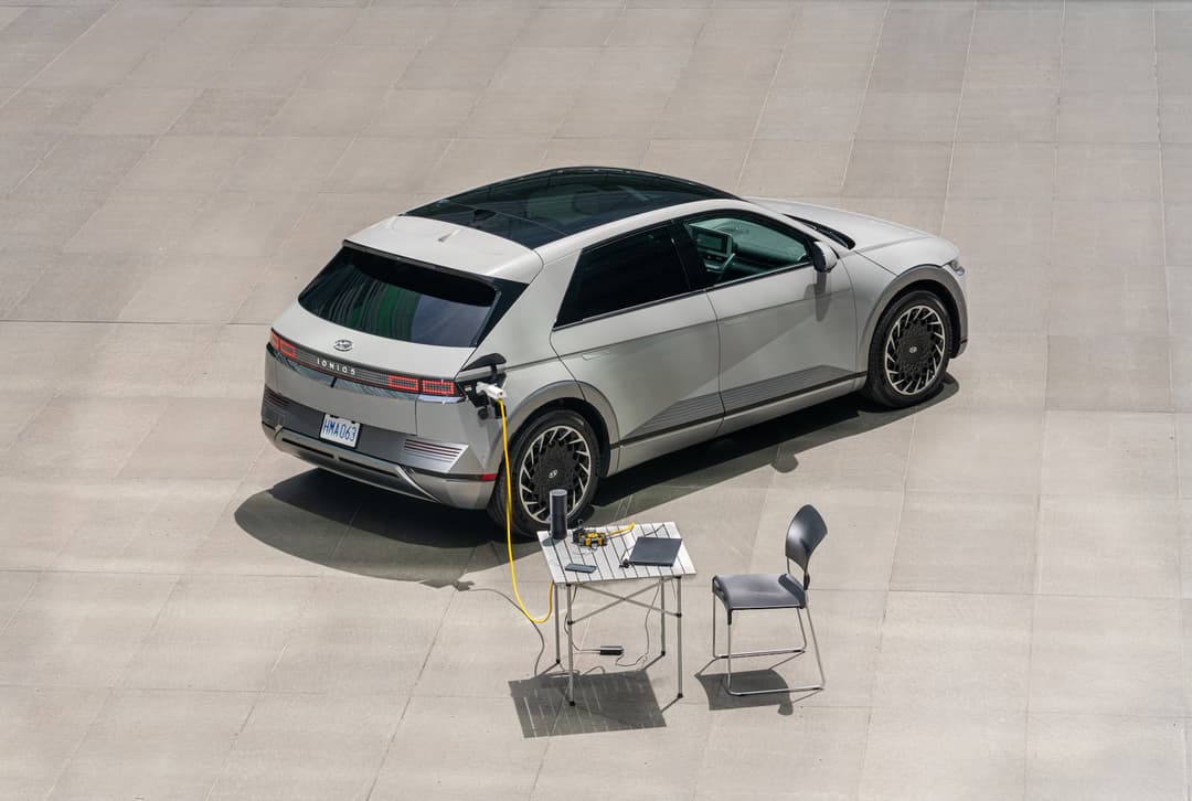 Matte Gravity Gold Hyundai Ioniq 5 discharging V2L into laptop and table Matte Gravity Gold Hyundai Ioniq 5 discharging V2L into laptop and table