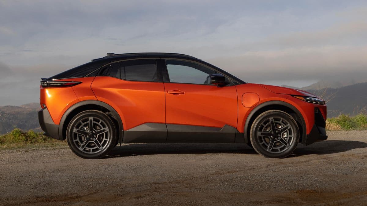 2026 Subaru Uncharted electric SUV in burnt orange parked showing its fastback silhouette and elevated ground clearance 2026 Subaru Uncharted electric SUV in burnt orange parked showing its fastback silhouette and elevated ground clearance