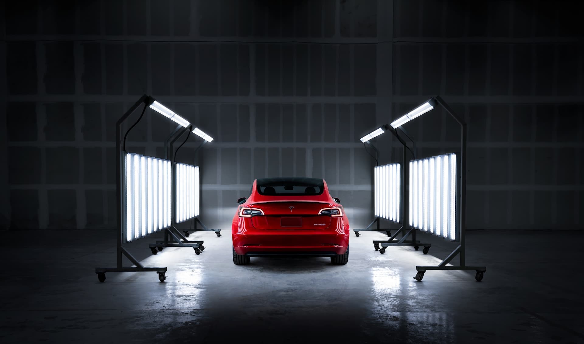 Red Tesla Model 3 in factory paint body inspection Red Tesla Model 3 in factory paint body inspection
