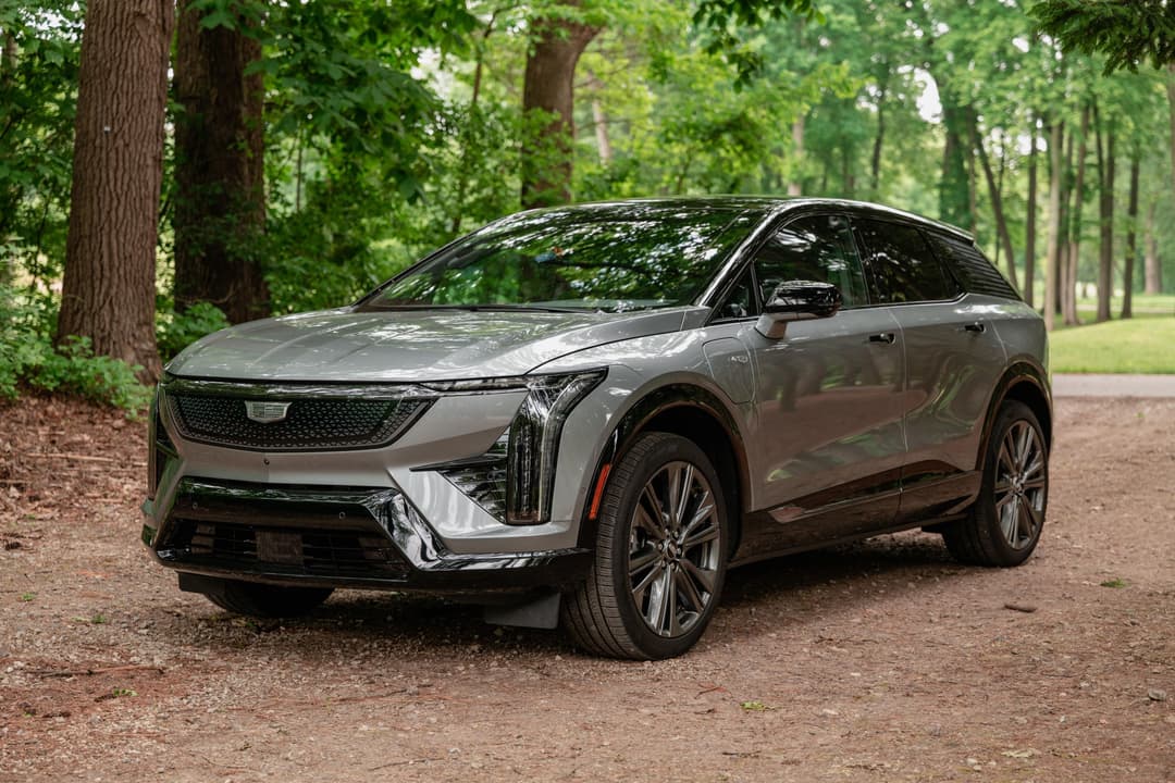 Cadillac Optiq electric SUV front three-quarter view showcasing the luxury EV's distinctive design and LED lighting signature Cadillac Optiq electric SUV front three-quarter view showcasing the luxury EV's distinctive design and LED lighting signature