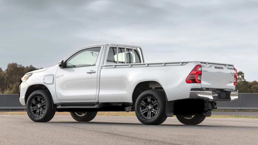 Electric Toyota HiLux in white side view in testing grounds Electric Toyota HiLux in white side view in testing grounds