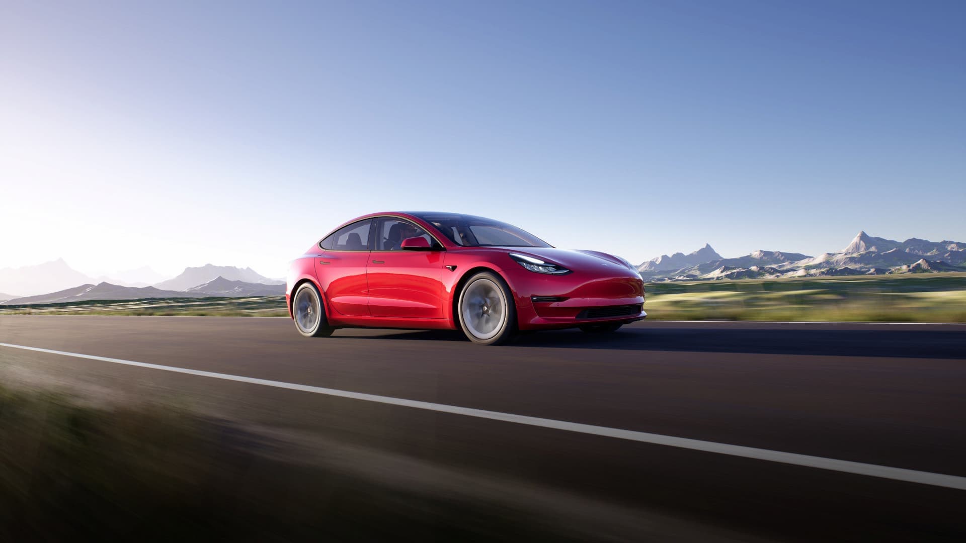 Red Tesla Model 3 driving Red Tesla Model 3 driving