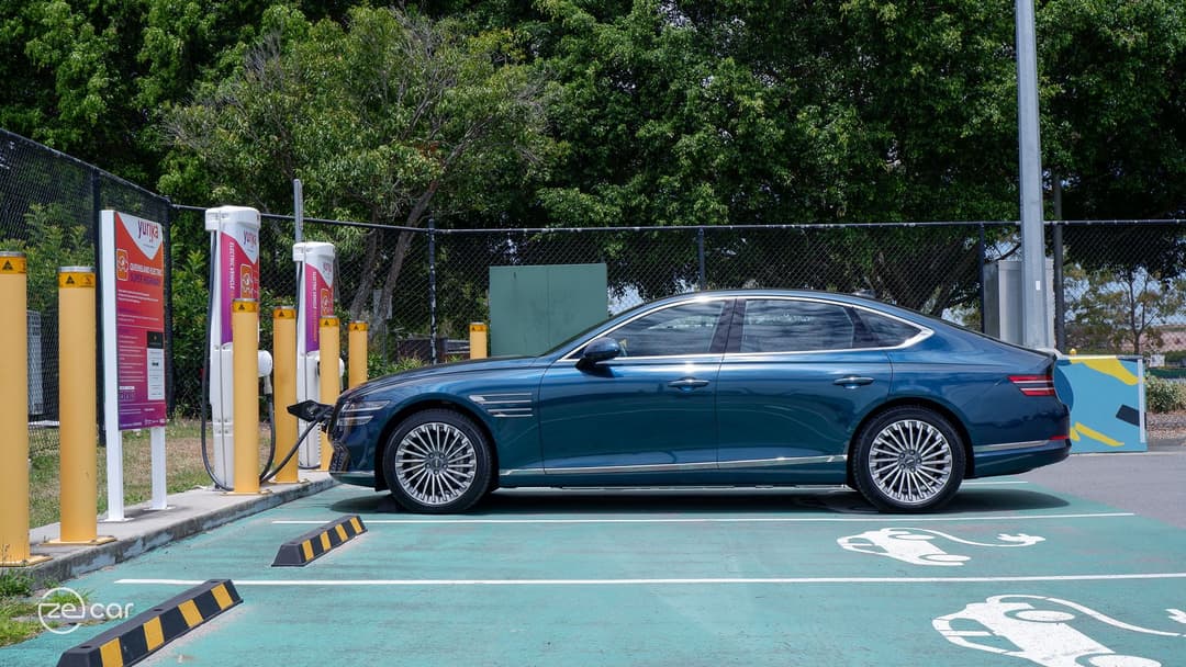 Genesis Electrified G80 plugged-in at DC Chargefox charger side view Genesis Electrified G80 plugged-in at DC Chargefox charger side view