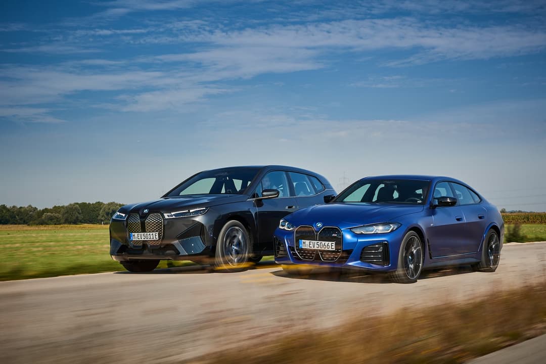 BMW iX and i4 electric cars driving BMW iX and i4 electric cars driving