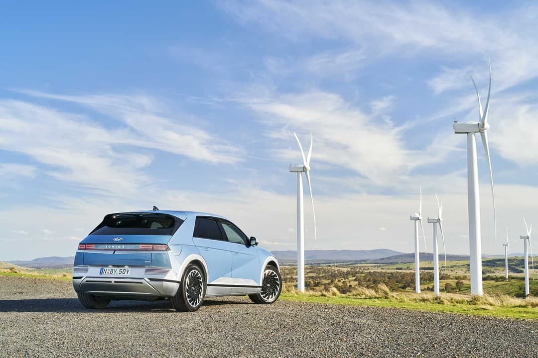 electric car next to wind farm electric car next to wind farm