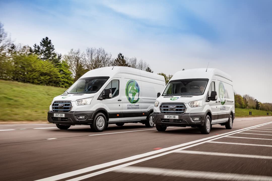 Two white Ford e-Transits driving Two white Ford e-Transits driving