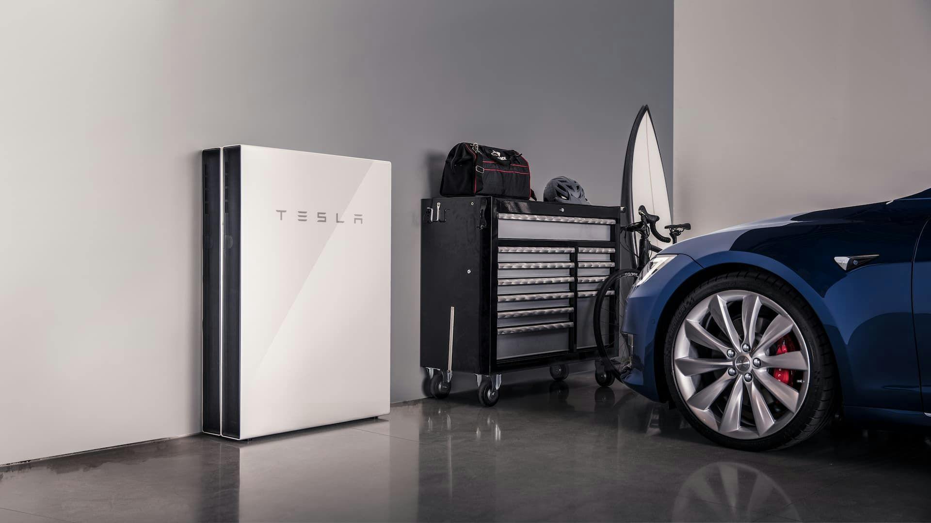 Tesla Powerwall 2 home battery next to Tesla Model S