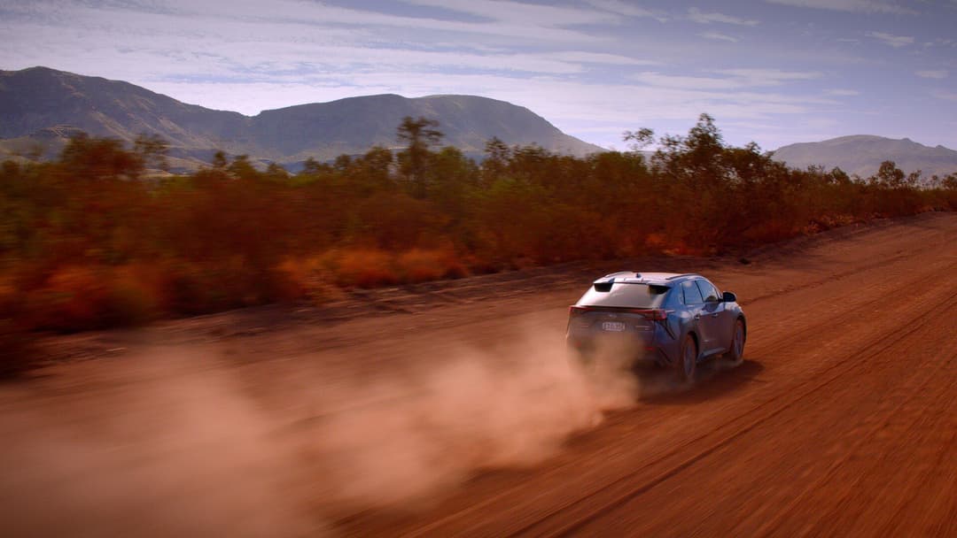 2024 Subaru Solterra rear view driving on dirt road 2024 Subaru Solterra rear view driving on dirt road