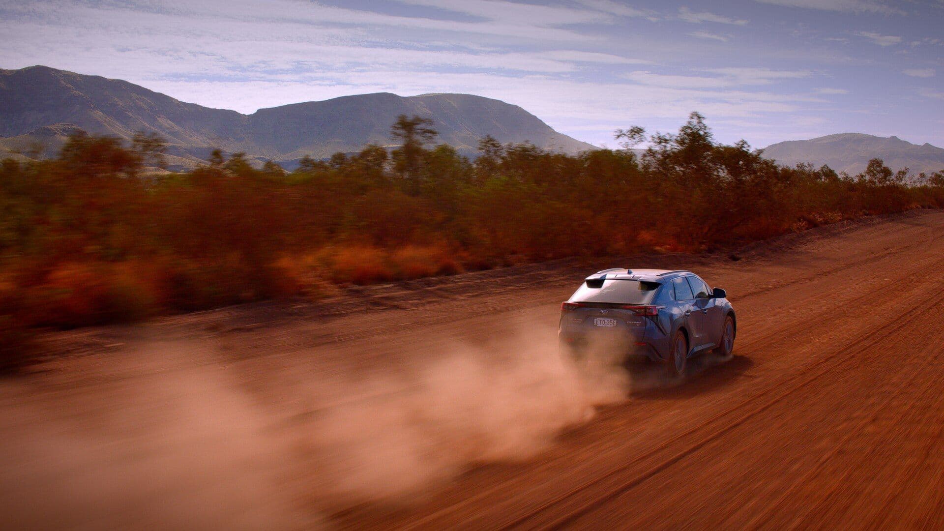 2024 Subaru Solterra rear view driving on dirt road 2024 Subaru Solterra rear view driving on dirt road
