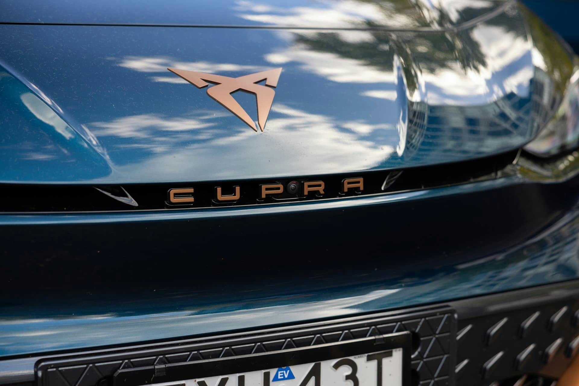 Cupra copper logo and lettering on Aurora Blue Cupra Born front grille