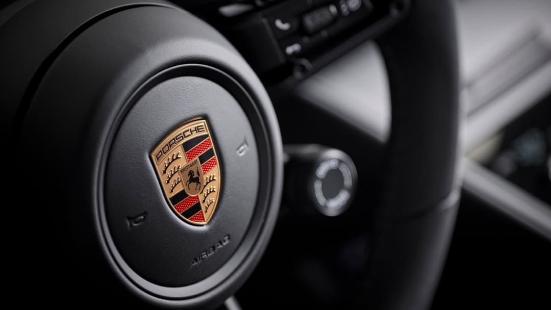 Porsche logo on Porsche Macan driver wheel Porsche logo on Porsche Macan driver wheel