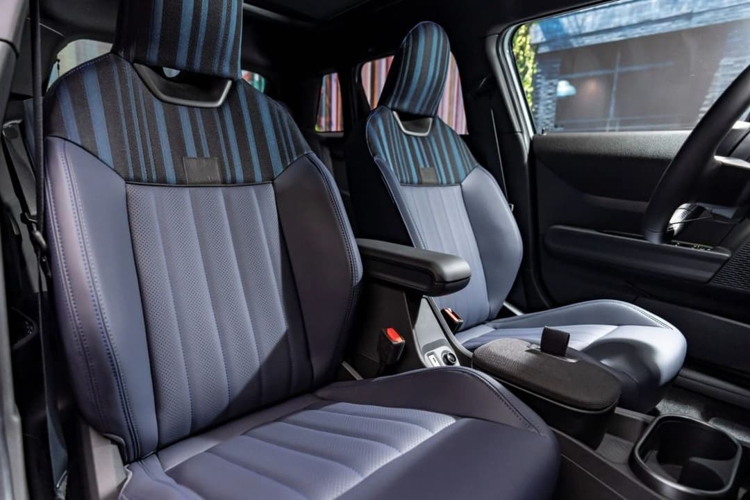 MINI Cooper SE Paul Smith Edition interior showing blue and grey striped vegan leather seats with black trim MINI Cooper SE Paul Smith Edition interior showing blue and grey striped vegan leather seats with black trim